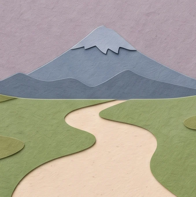 A pale cream path winding through green grass toward a blue snow-capped mountain, seen through an arch of roses
